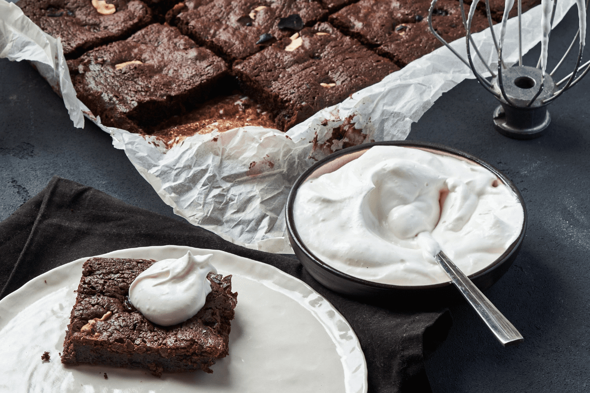 Indulge in this gluten-free sweet potato brownie topped with whipped coconut cream—a healthy and delicious dessert option for any occasion!